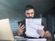 Verifactu-man-analyzing-documents-at-home-workplace-2026-01-05-00-41-34-utc